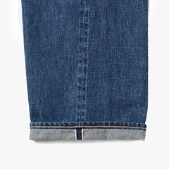 Close-up of the dark blue denim fabric showing texture, weave, and depth of color.