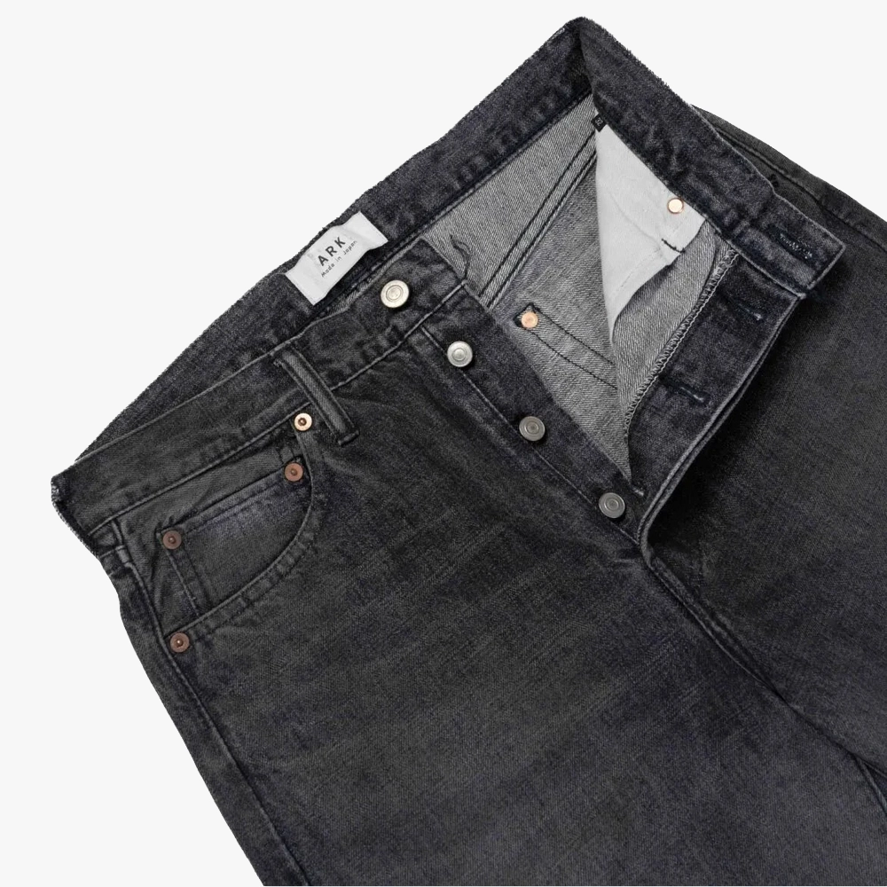 Close-up of the waistband and top button on the Ark Madison Black Jeans showing stitching, hardware, and clean finishing.