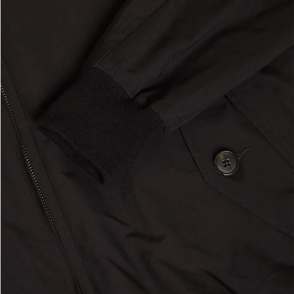 Close-up of the flap pocket showing button closure and refined stitching.