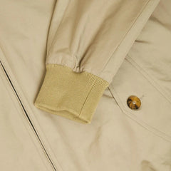 Close-up of the flap pocket showing button closure and refined stitching.