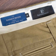 Close-up of the brand tag on the Barnstormer Officer Chino Olive showing label design, stitching, and placement inside the waistband.