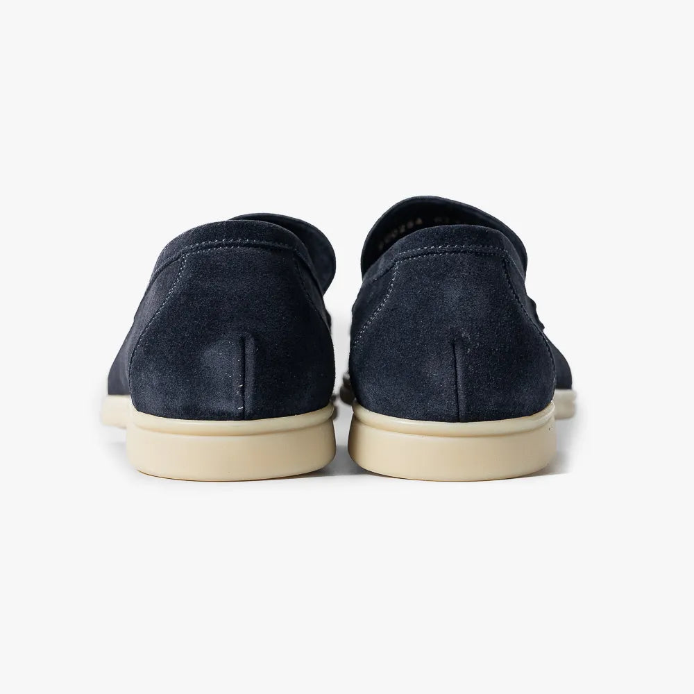 Close-up of the heel block showing stacked construction, stitching, and structured shaping.