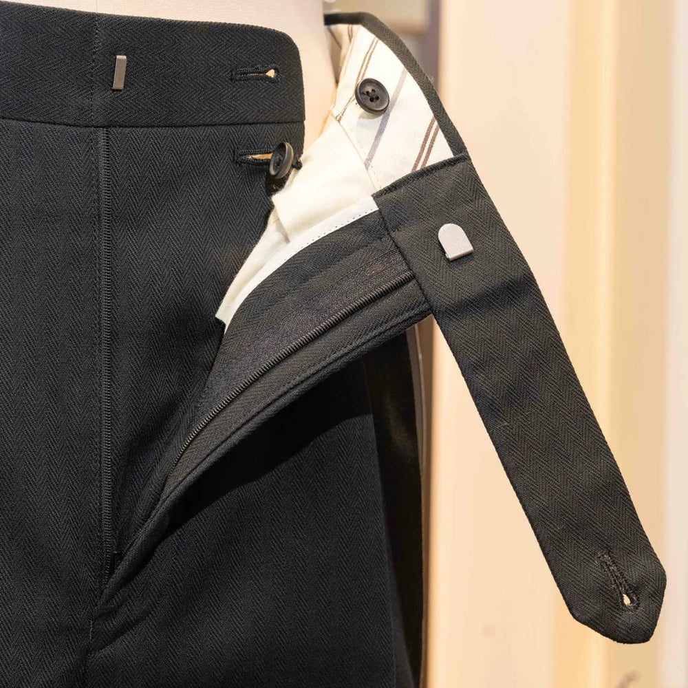 Close-up of the waistband button on the Calsa Nagasaki Trousers Cotton Herringbone Black