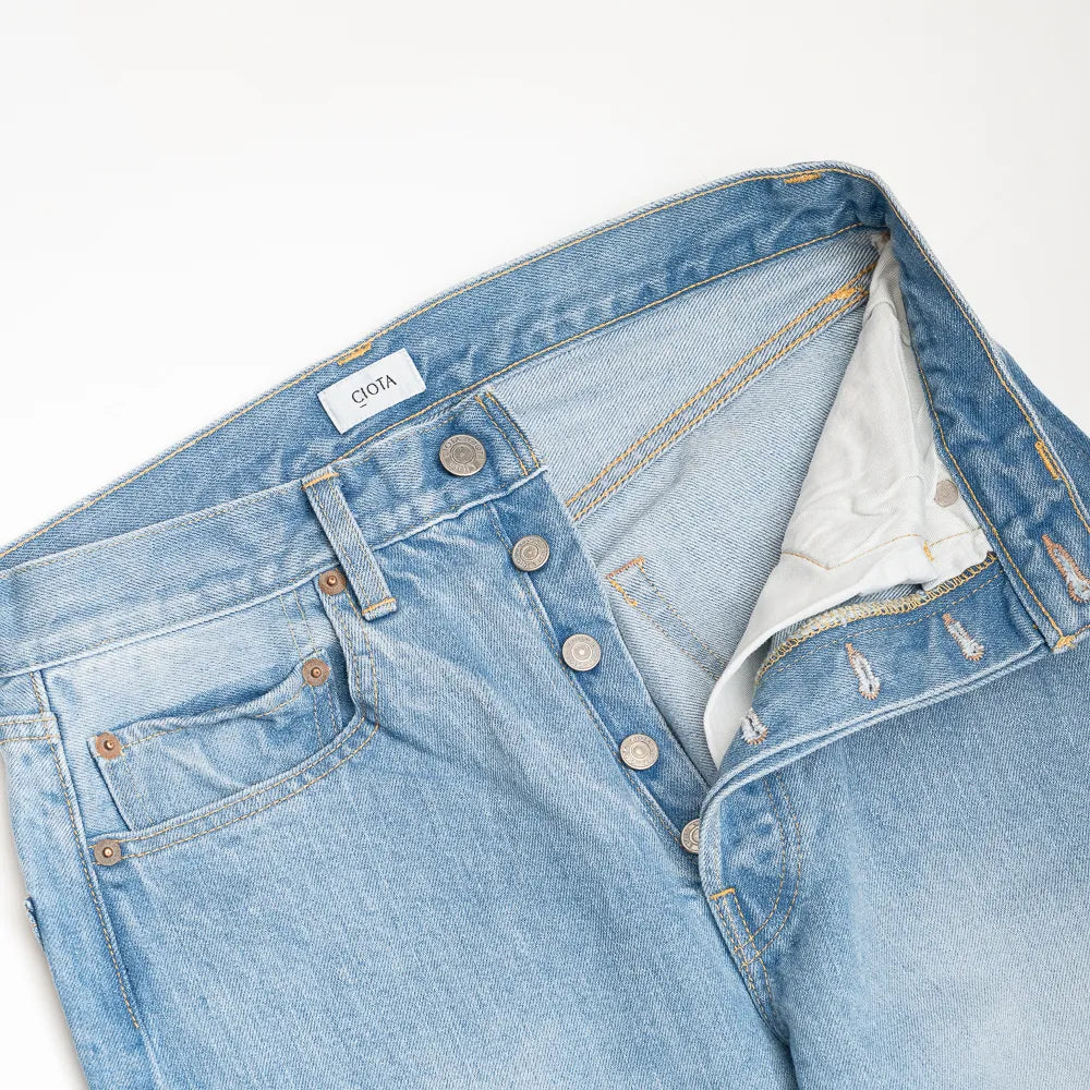 Close-up of the waistband showing button closure and belt loop construction.