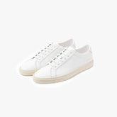 Full view of the Common Projects Achilles Premium 2572 in off white showing the minimalist low-top silhouette and clean design.