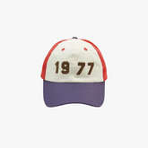 Front view of the Drake’s 1977’ Cotton Twill Baseball Cap showing the embroidered “1977” graphic and structured cotton twill panels.