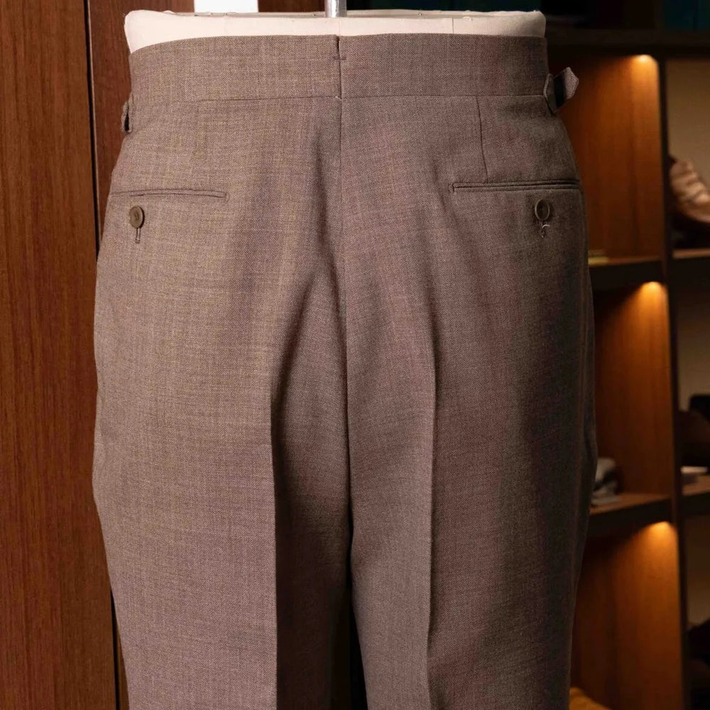 Back view of the Drummers Trousers Beige highlighting the back pockets, seam finishing, and structured drape.