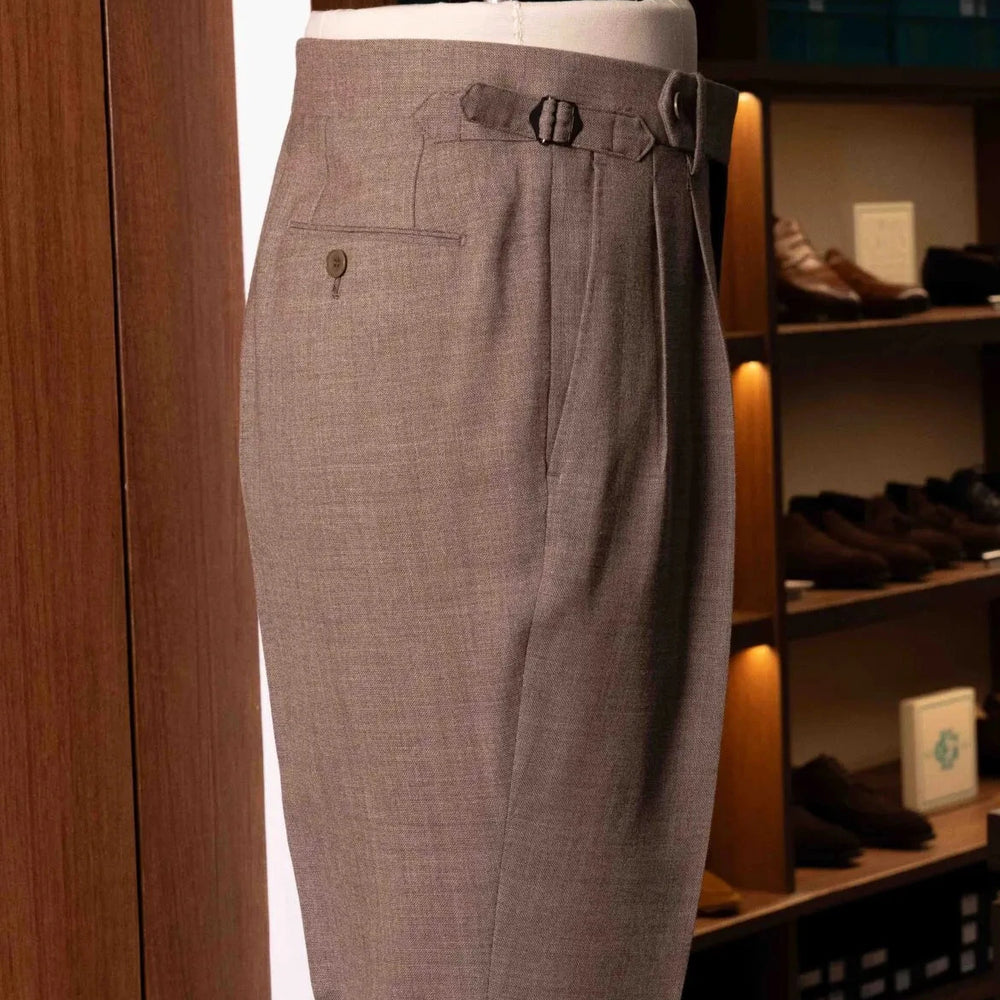 Side view of the Drummers Trousers Beige showing the straight leg shape, side seams, and refined tailoring.