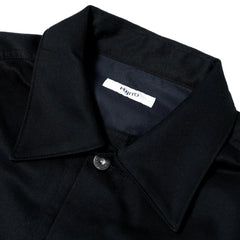 Close-up of the collar and front placket highlighting button closure and fabric texture.