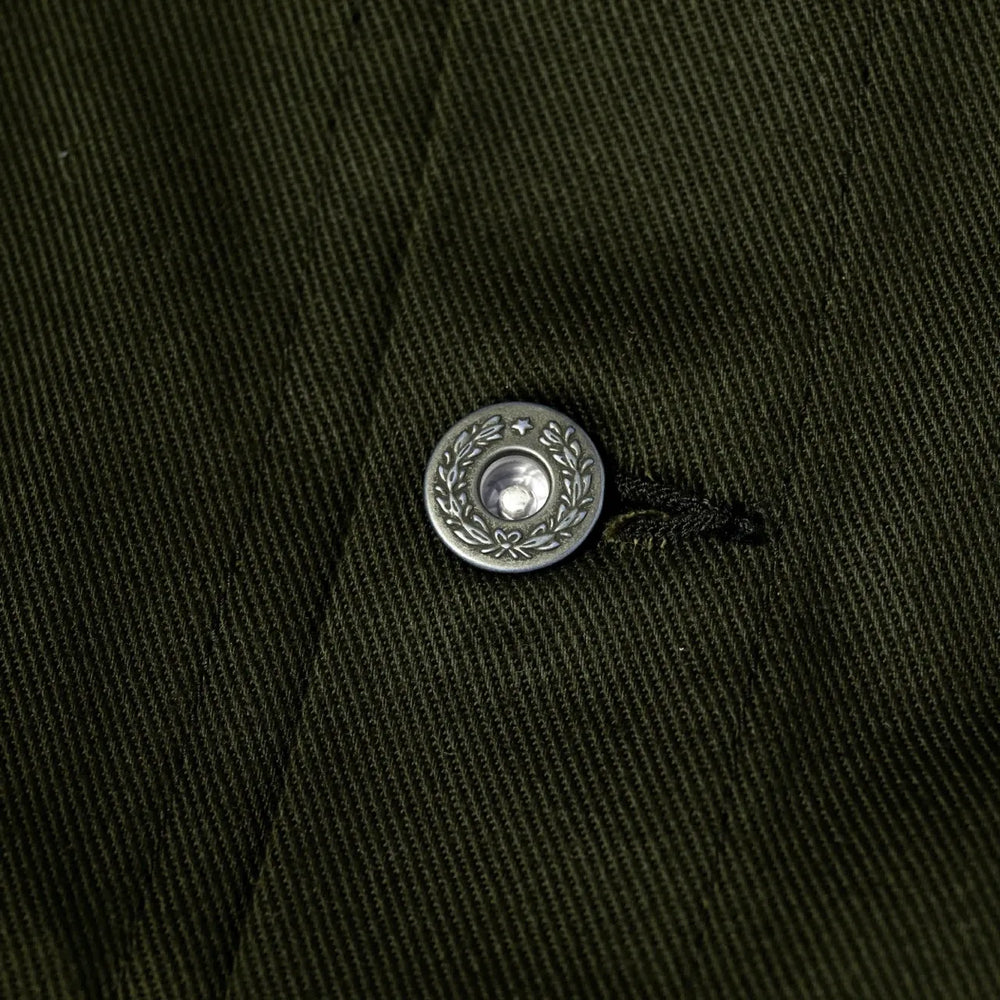 Close-up of the sleeve cuff showing button fastening and clean finishing.