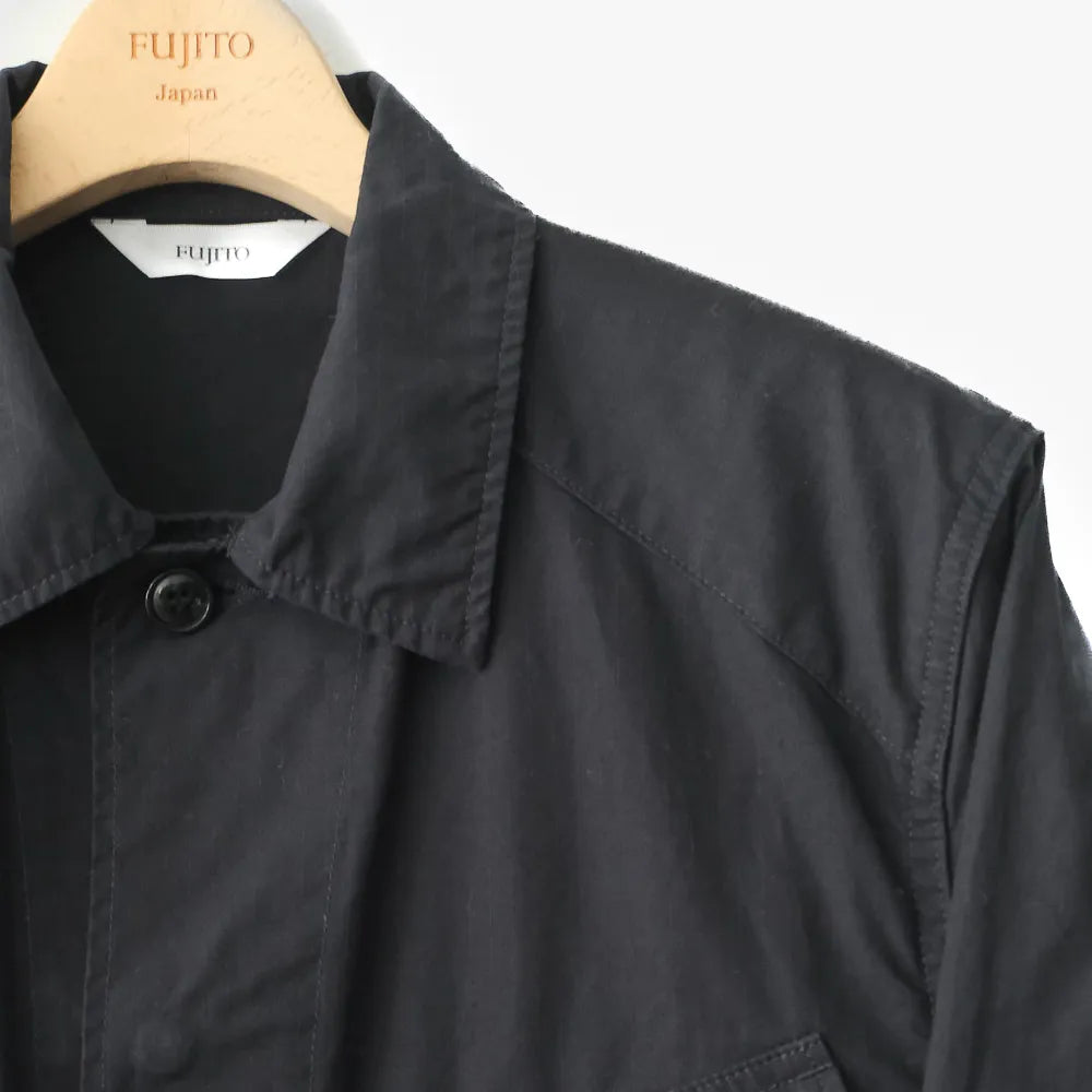 Close-up of the navy fabric showing weave texture, durability, and refined utilitarian character.