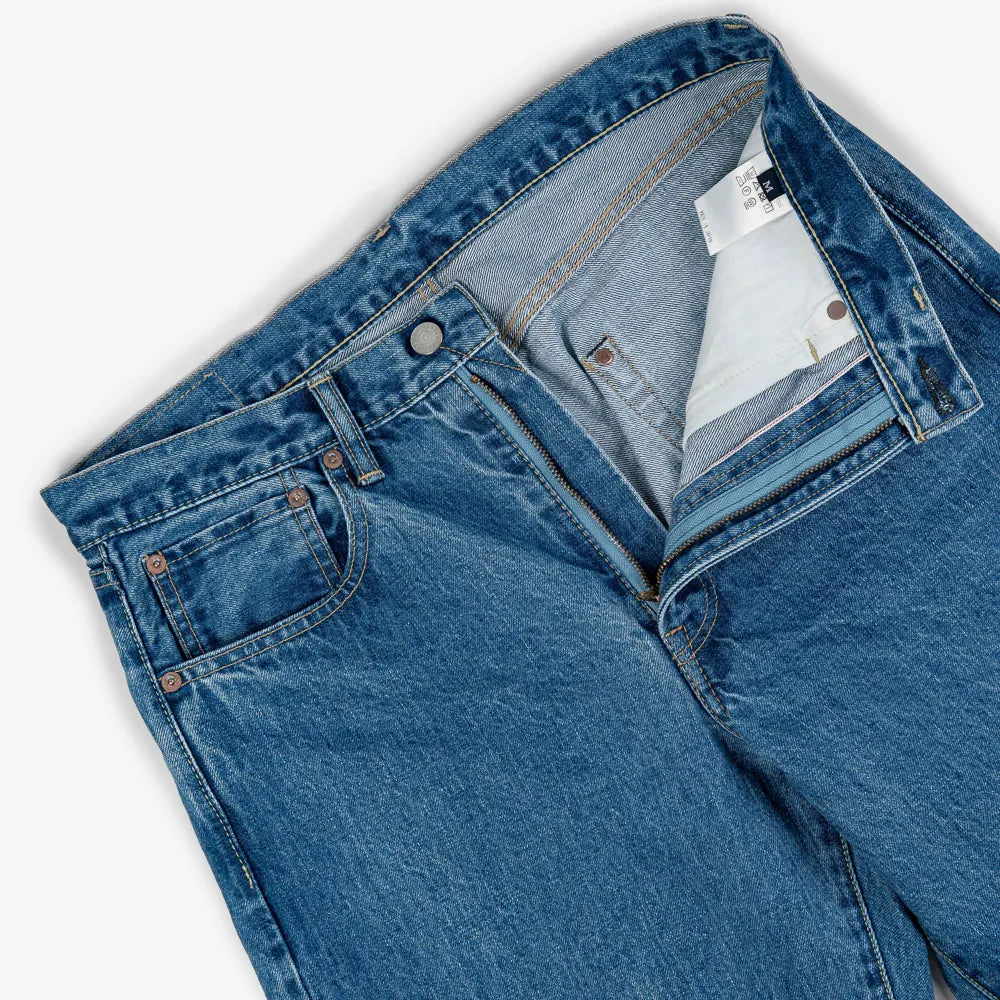 Close-up of the waistband button on the Hand Room Exclusive for Refinement Wide Fit Light Washed jeans