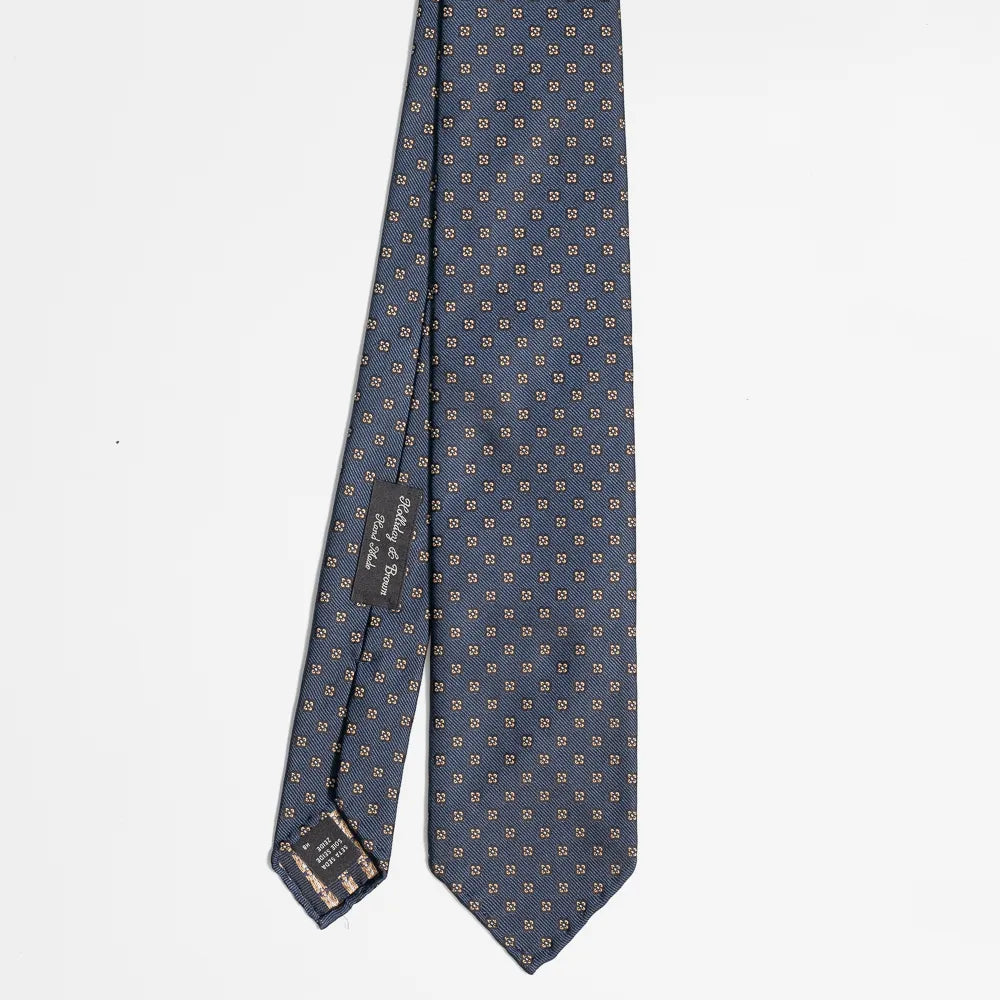 Full view of the Holliday & Brown floral tie in navy showing elegant floral pattern and refined proportions.