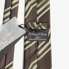 Close-up of the brown and green jacquard pattern highlighting silk texture and intricate weave detail.