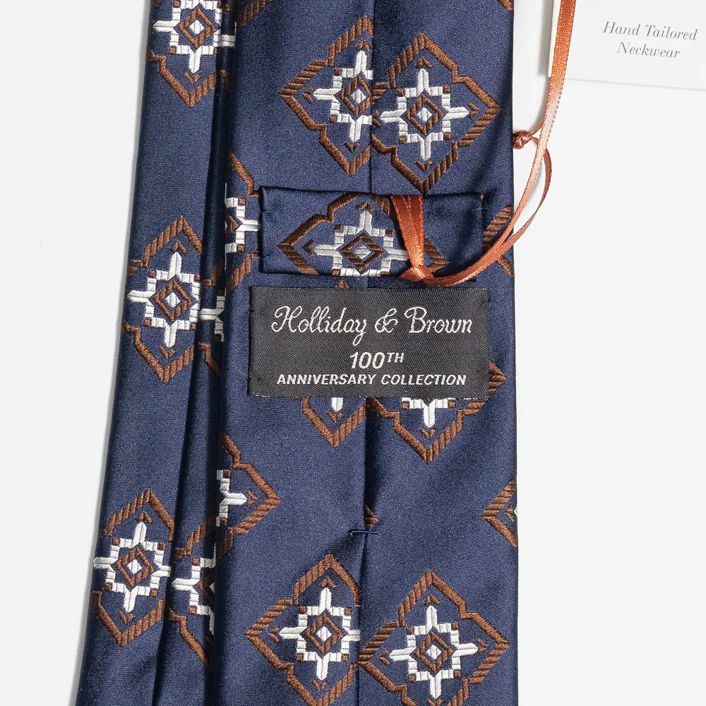 Close-up of the navy and brown jacquard pattern highlighting silk texture and intricate weave detail.