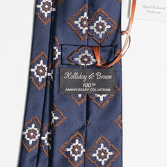 Close-up of the navy and brown jacquard pattern highlighting silk texture and intricate weave detail.
