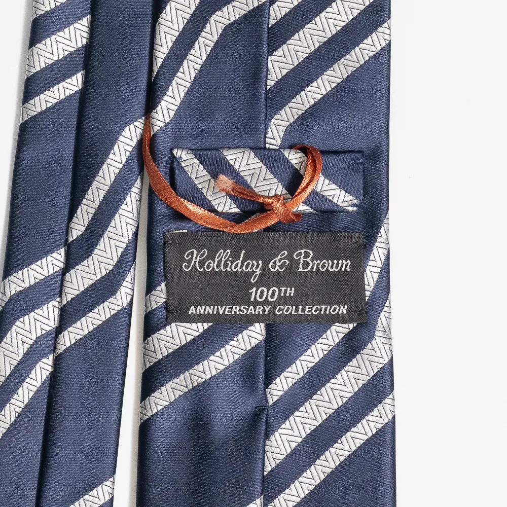 Close-up of the navy and ivory jacquard pattern highlighting silk texture and intricate weave detail.