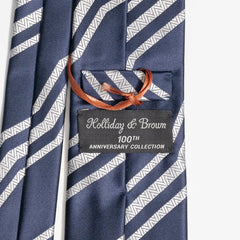 Close-up of the navy and ivory jacquard pattern highlighting silk texture and intricate weave detail.
