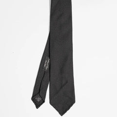 Full view of the Holliday & Brown knit tie in black showing classic slim proportions and textured knit construction.