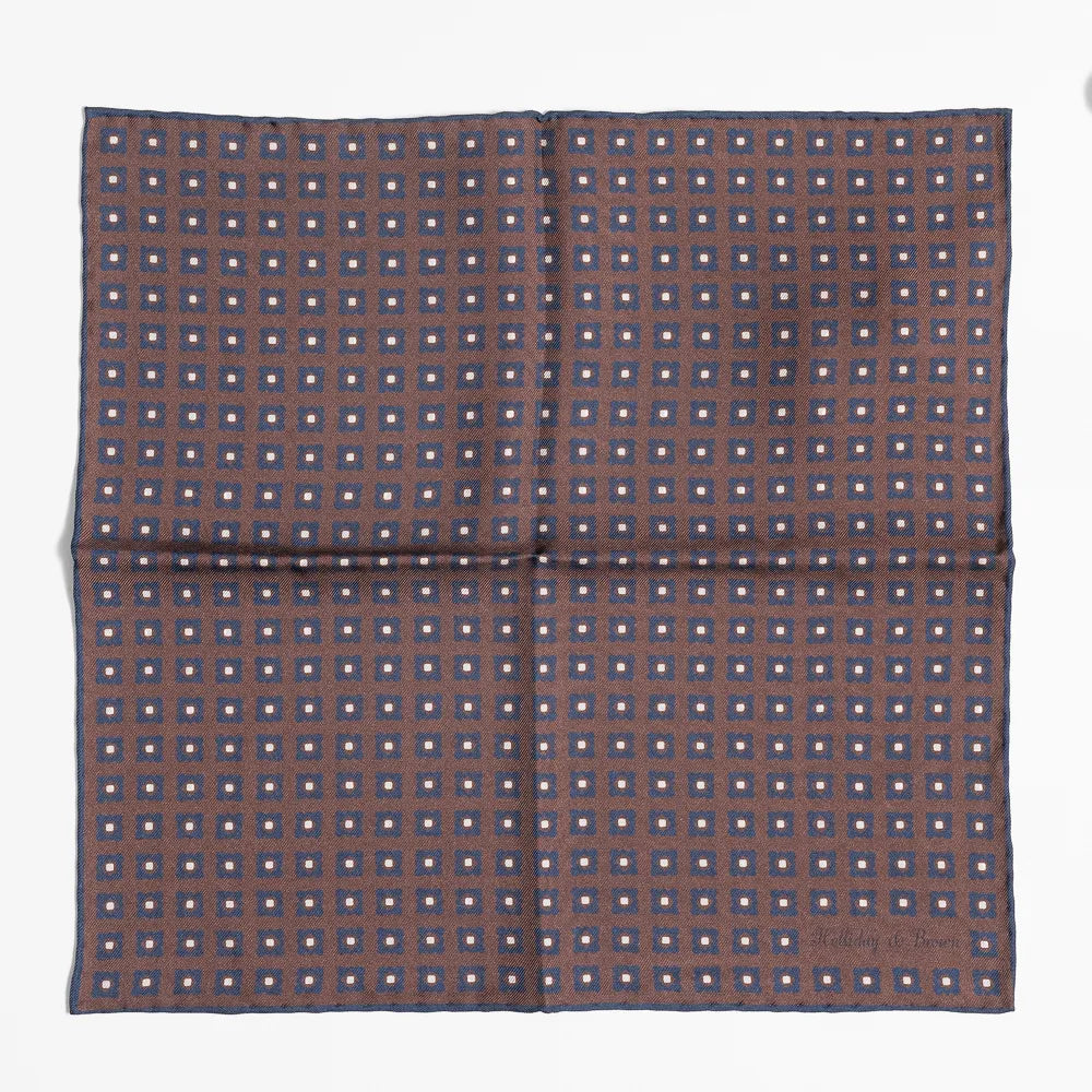 Full view of the Holliday & Brown dot pocket square in brown showing classic polka dot pattern and refined proportions.