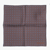 Full view of the Holliday & Brown dot pocket square in brown showing classic polka dot pattern and refined proportions.