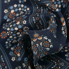 Close-up of the Holliday & Brown pocket square in navy showing the soft drape, weave texture, and intricate print work.