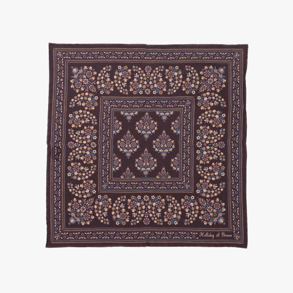Full view of the Holliday & Brown pocket square in plum, showing the complete pattern layout, rich plum tone, and bordered design.