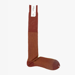 Full view of the Il Regalo Reversible Over The Calf Socks in Terracotta & Saffron showing the elongated silhouette, rib knit texture, and reversible color design.