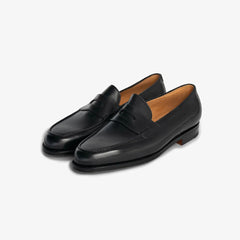 John Lobb Lopez loafer in black calf leather, angled front view showing apron and strap.