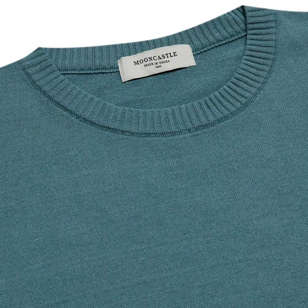 Close-up of the ribbed crew neck collar showing knit density, structure, and precise stitching.