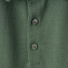 Close-up of the polo collar highlighting the structured knit collar and button placket detail.