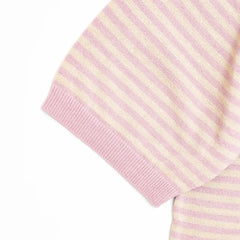 Close-up of the sleeve showing the knit texture and ribbed cuff finishing.