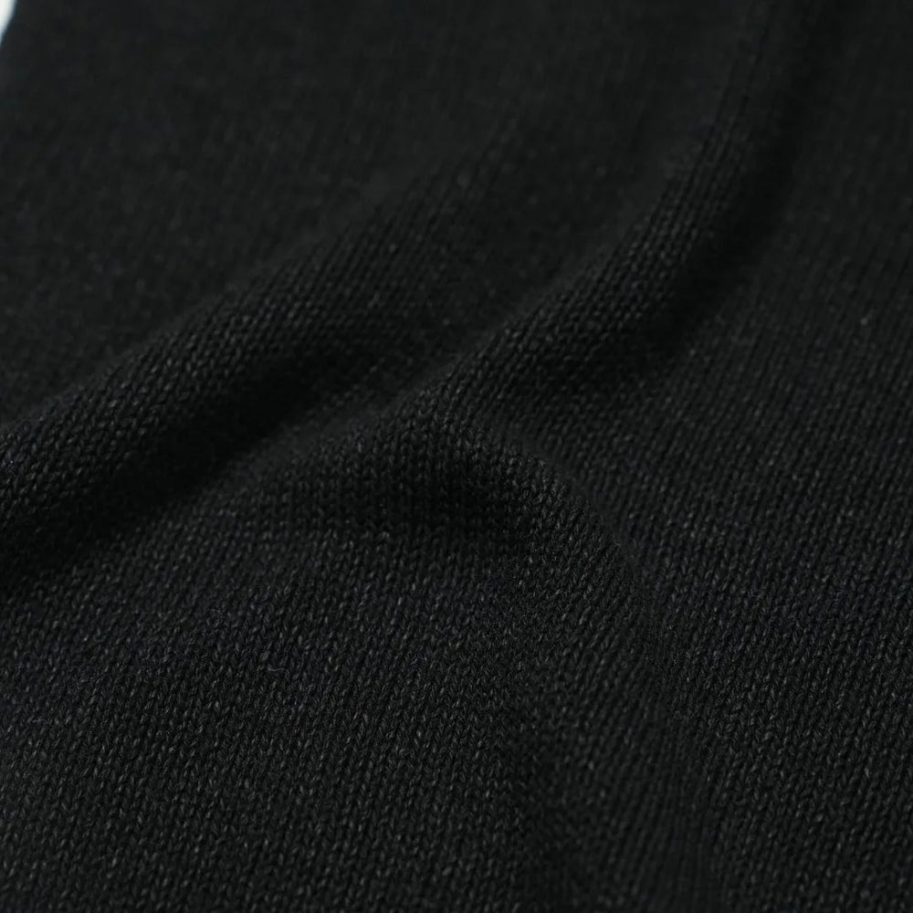 Close-up of the paper-silk blend fabric showing its ultra-light texture, soft handfeel, and matte black appearance.
