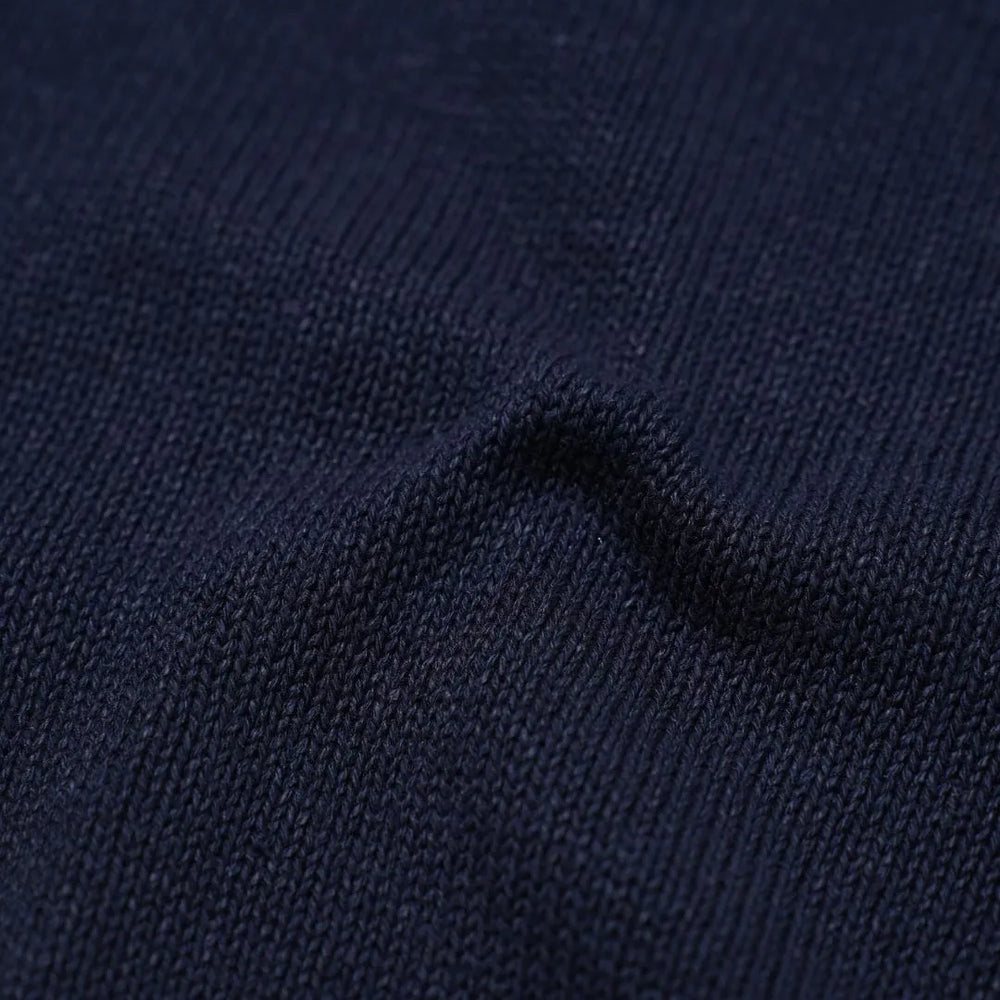 Close-up of the paper-silk blend knit showing its ultra-light texture, soft touch, and subtle navy sheen.
