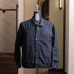 Front view of the Nanamica Short Denim Jacket in indigo featuring a cropped silhouette and clean structured design.