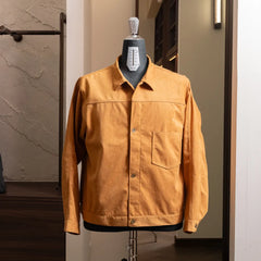 Front view of the Nanamica Synthetic Leather Short Jacket in camel featuring a clean cropped silhouette and structured design.