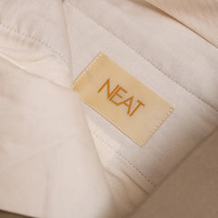 Close-up of the NEAT brand label inside the trousers.