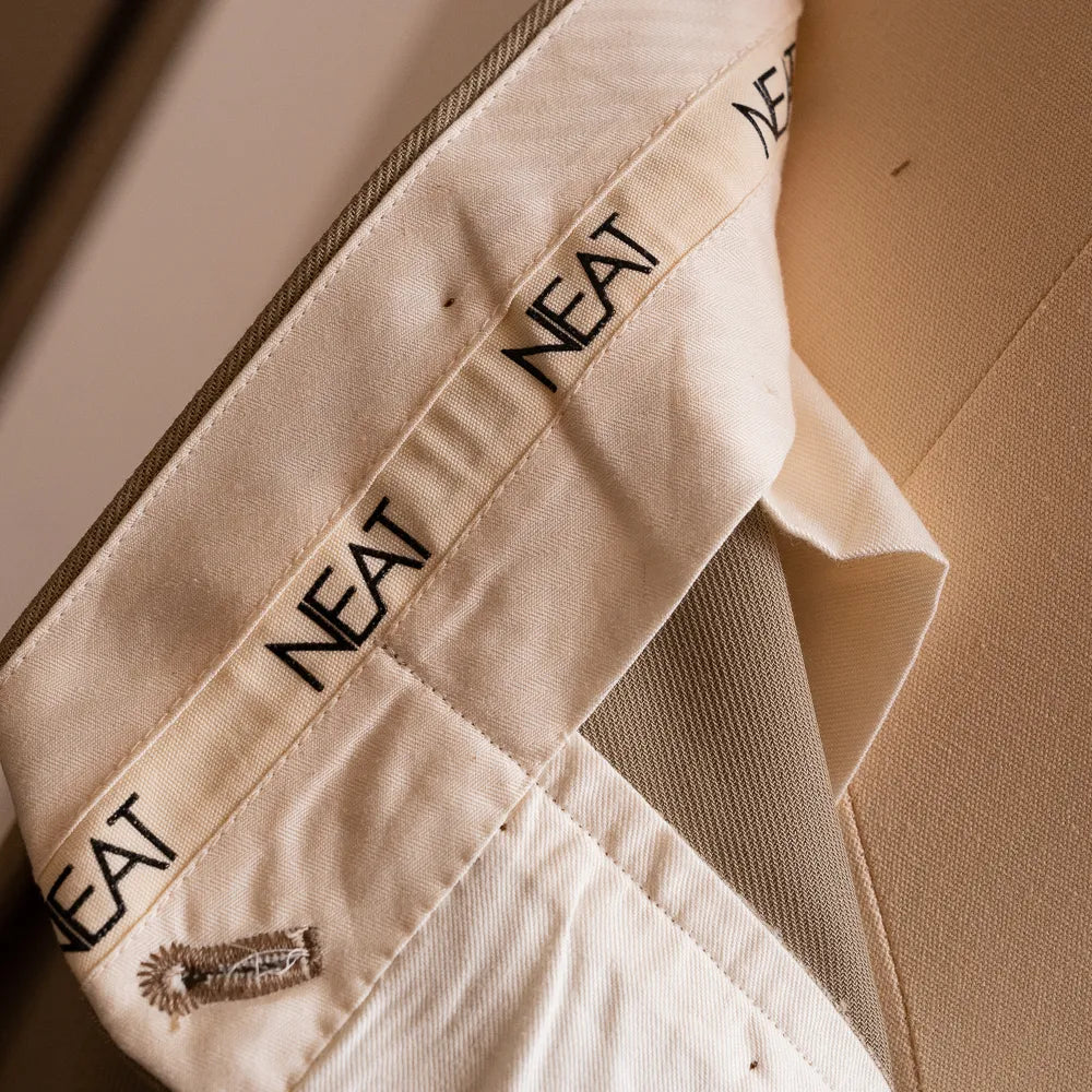 Close-up of the inner lining and NEAT branding showing refined finishing.