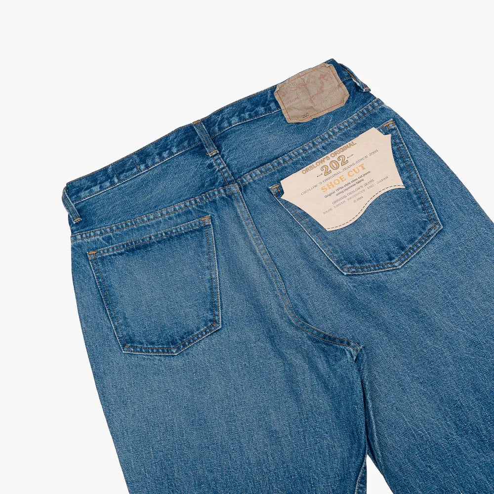 Close-up of the back pocket showing stitching, pocket shape, and natural two-year wear.