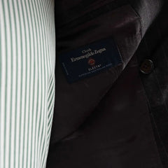 Close-up of the interior labels on the RMJ-04 Chalk Stripe Charcoal Grey Suit showing Refinement Made By Ring Jacket branding and Ermenegildo Zegna Electa fabric label.