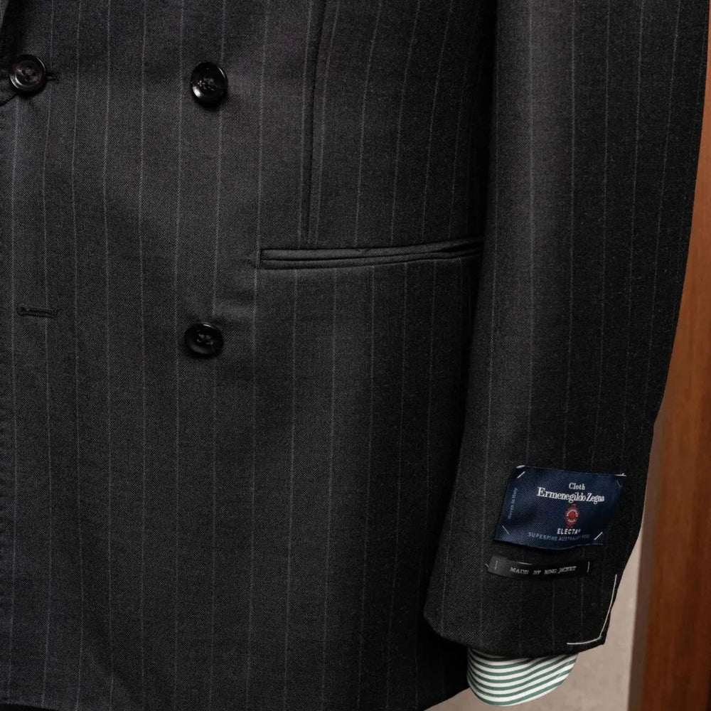 Close-up of the sleeve and hem area highlighting sleeve buttonwork, stitching, and clean finishing on the RMJ-04 Chalk Stripe Charcoal Grey Jacket.