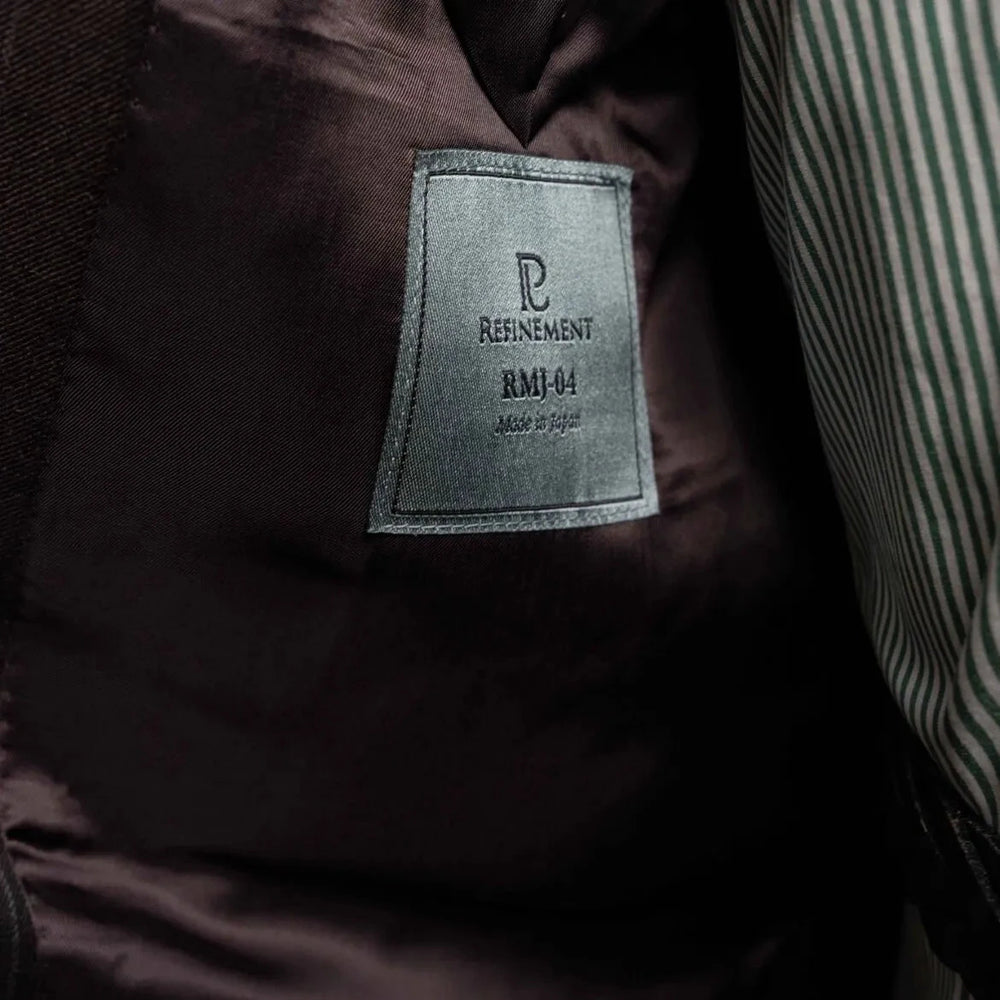 Close-up of the interior labels showing Refinement Made By Ring Jacket branding and the Ermenegildo Zegna Electa fabric label.