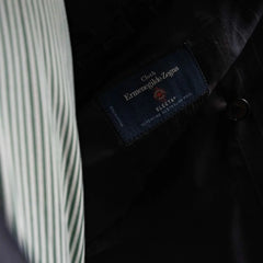 Close-up of the interior labels on the RMJ-04 Chalk Stripe Navy Suit showing Refinement Made By Ring Jacket branding and Ermenegildo Zegna Electa fabric label.