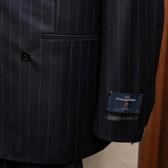 Close-up of the sleeve and hem area showing sleeve buttonwork, stitching, and clean finishing on the RMJ-04 Chalk Stripe Navy Jacket.