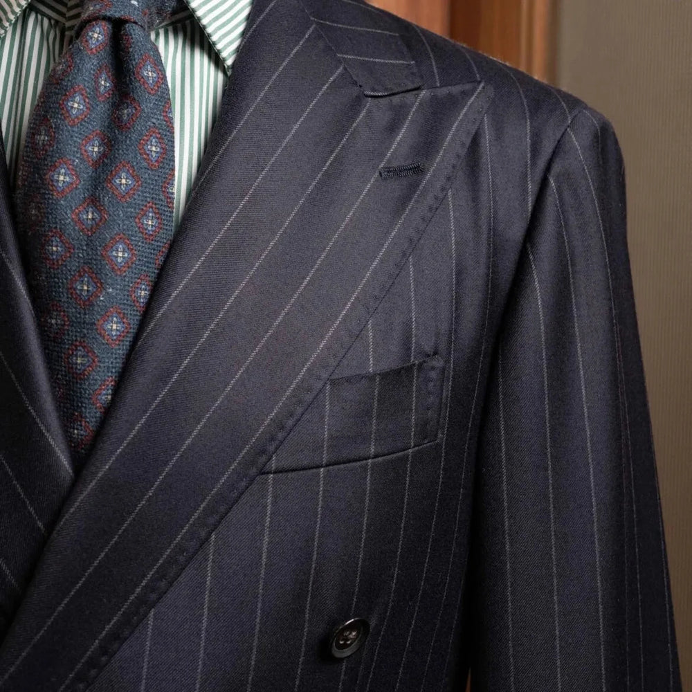 Close-up of the peak lapel on the RMJ-04 Chalk Stripe Navy Jacket showing the lapel roll, sharp peak shape, and the luxurious Zegna Electa wool texture.