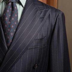 Close-up of the peak lapel on the RMJ-04 Chalk Stripe Navy Jacket showing the lapel roll, sharp peak shape, and the luxurious Zegna Electa wool texture.