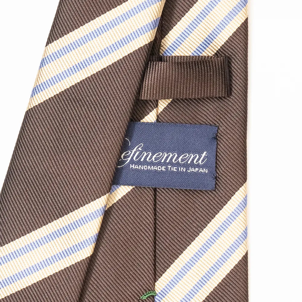 Close-up of the Refinement repp stripe neck tie showing the textured silk weave and brand label detail.