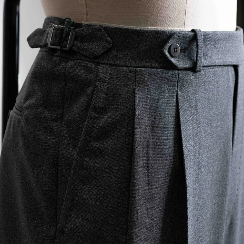 Close-up of the waistband showing button closure, belt loops, stitching precision, and Drapers tailoring quality.