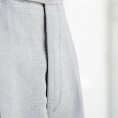 Close-up of the front pleat or flat-front structure showing clean tailoring lines.