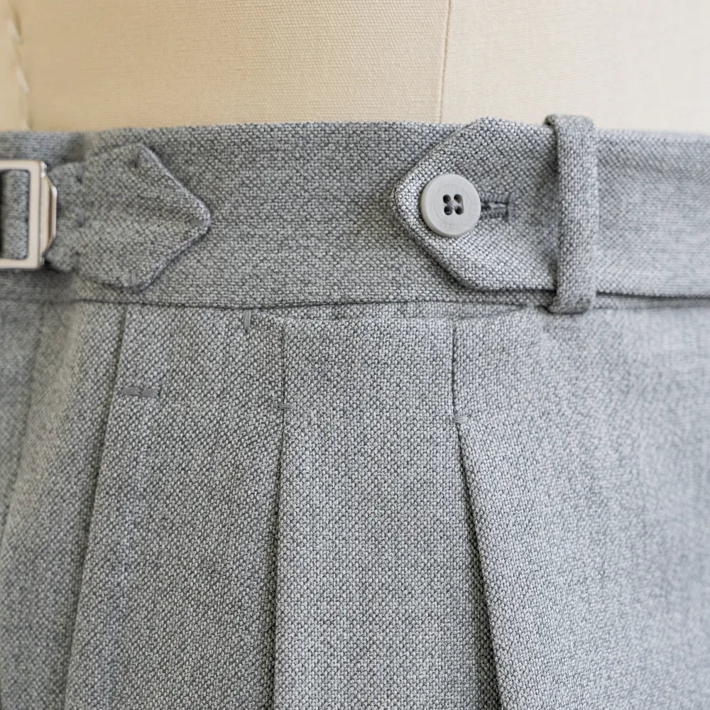 Side view showing the tailored leg line, straight fall, and crisp silhouette of the light grey wool.